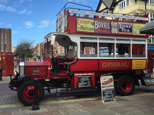 an old red bus is parked on a street at Chester House Guest House in Chester