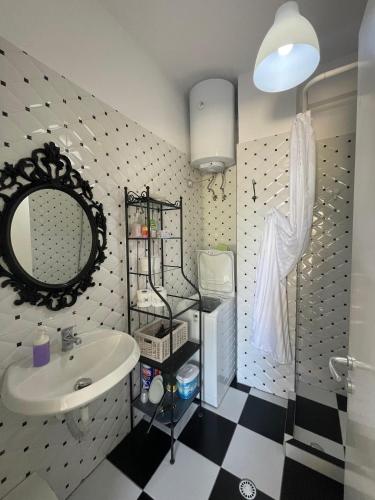 a bathroom with a sink and a mirror at Renissa's Beach Suite in Vlorë