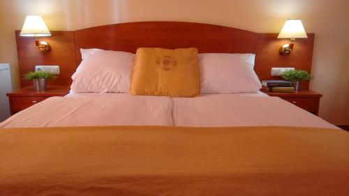 a bedroom with a large bed with two pillows at Aparthotel Lekavski in Zaton