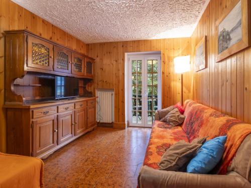 a living room with a couch and a tv at Apartment Casa Rossa by Interhome in Madesimo
