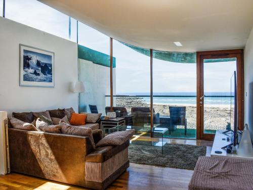 a living room with a couch and a view of the ocean at The Balcony in Westward Ho
