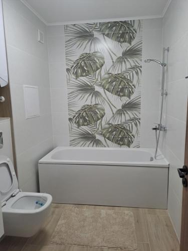 a bathroom with a bath tub and a toilet at MarVi home in Ruse