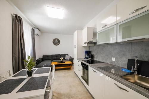 a kitchen and living room with a couch at Gasparevic Apartments in Rovinj