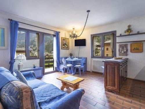 a living room with a blue couch and a table at Apartment Casa Cavalieri by Interhome in Valdisotto