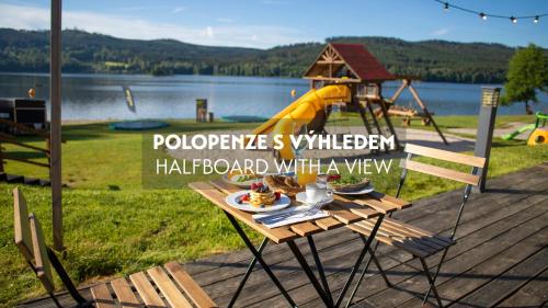 a table with food on it next to a playground at Amenity Hotel & Resort Lipno in Lipno nad Vltavou