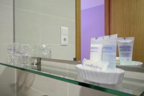 a glass counter top with someental products on it at Dormavalencia Hostel in Valencia