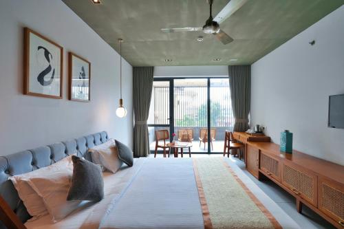 a living room with a bed and a television at E.05 City Inn in Alwaye