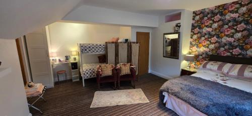 a bedroom with a bed and a table and a mirror at Island House in Lanercost