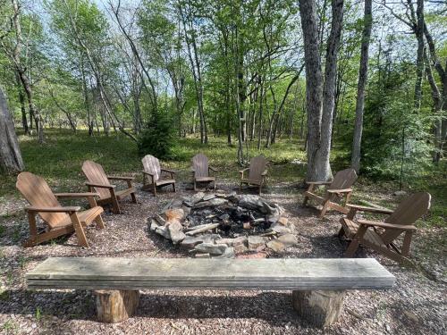 a group of chairs sitting around a fire pit at Evergreen Escape - Jim Thorpe Multi Ski Resort in Albrightsville