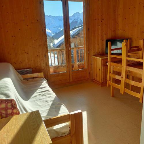 a room with a bed and a television in a cabin at Studio plein sud avec piscine in Saint-Jean-dʼArves