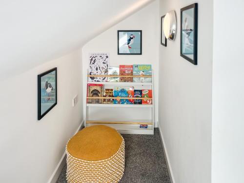 a stairway with a stool in a room at Strandside Townhouse in Bude