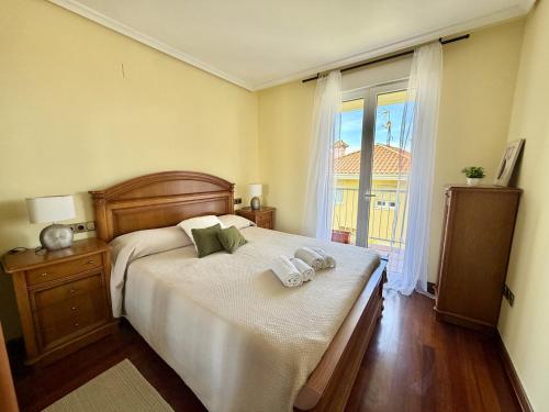 a bedroom with a large bed and a window at Apartamento Albamar 32802 in Pedreña