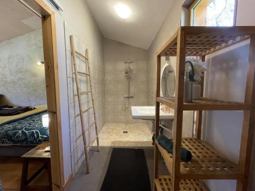 a small bathroom with a sink and a shower at Source Nature in Le Mas-dʼAzil