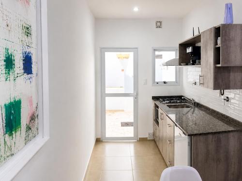 a kitchen with a sink and a counter top at C1 Suite in Las Varillas