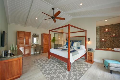 a bedroom with a bed and a ceiling fan at Serenity at Coconut Bay All Inclusive - Couples Only in Vieux Fort