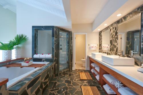 a bathroom with two sinks and a shower at Serenity at Coconut Bay All Inclusive - Couples Only in Vieux Fort