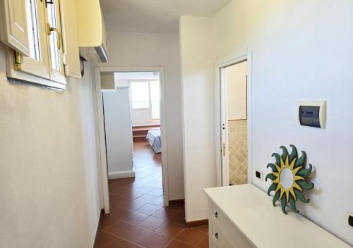 a kitchen with a white counter and a hallway at Appartamenti Capo d'Arco in Capo D'Arco
