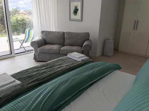 a living room with a bed and a couch at Hillfort suites in Lostorf
