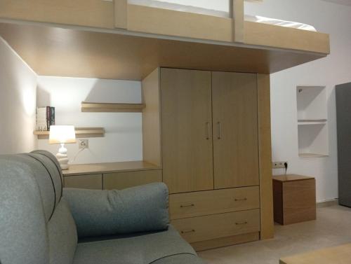 a living room with a loft bed and a couch at Kimourioti Green House in Sitia