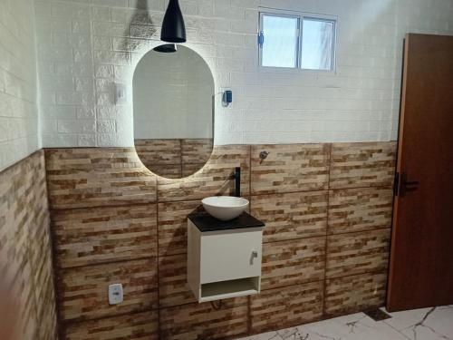 a bathroom with a sink and a mirror at Sitio Daniel in Mateus Leme