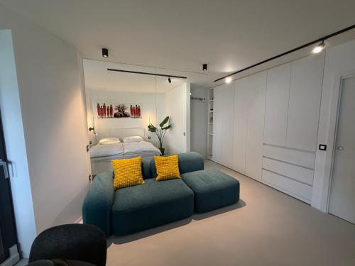 a bedroom with a bed and a couch with yellow pillows at Vacation Station Kamnik in Kamnik
