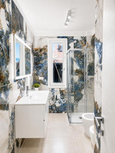 a bathroom with a white sink and a shower at Villa Gaspare in Lido di Jesolo