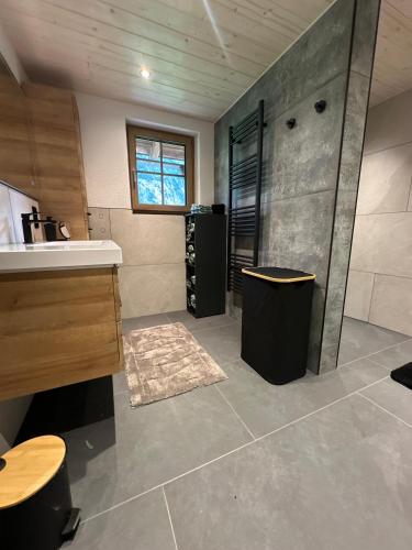 a bathroom with a sink and a shower and a counter at Ferienwohnung Loifried in Abtenau