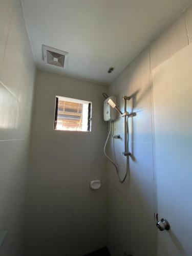a bathroom with a shower and a window at Villa Peray Siargao in General Luna