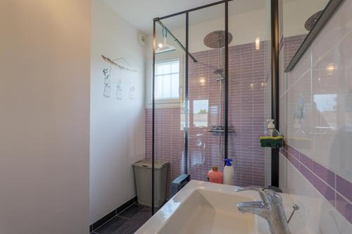 a bathroom with a sink and a glass shower at Résidence Château Saint Martin in Saint-Martin-dʼArdèche