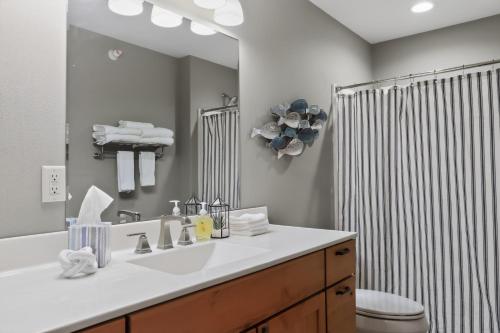 a bathroom with a sink and a toilet and a mirror at Big Spirit Resort in Spirit Lake