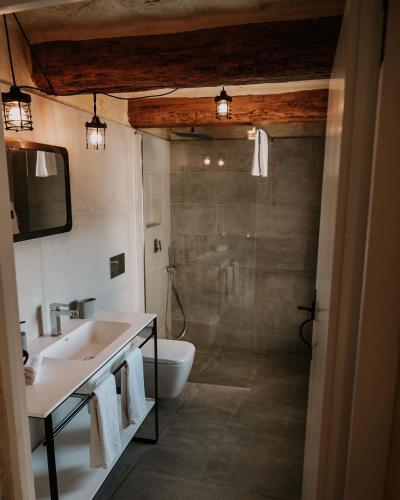 a bathroom with a shower and a sink and a toilet at Villa La Mola Gozo Luxury Villa with Private Pool & Sunset Views in Għasri