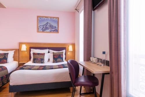 a hotel room with a bed and a table and a desk at Grand Hotel Dore in Paris