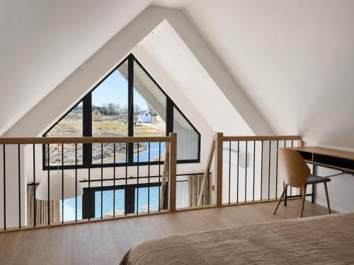 a bedroom with a bed and a large window at Pirtelių resort - Pilkasis namelis in Kiauleikiai