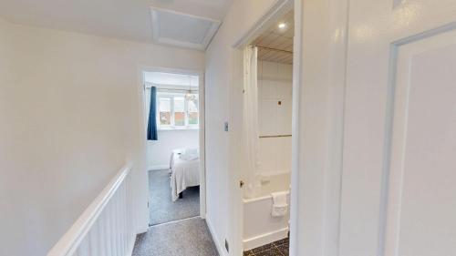 a white bathroom with a sink and a toilet in a room at Buckland Mews in Abingdon