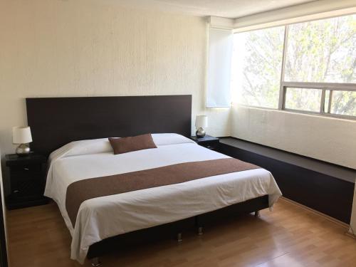 A bed or beds in a room at Bosque de Magnolias 93