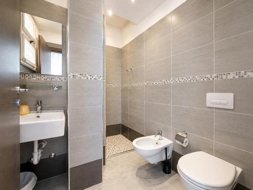 a bathroom with a toilet and a sink at Hotel TYC in Rimini