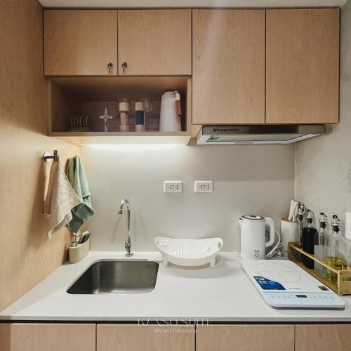 a small kitchen with a sink and a counter at Studio with Free Pool Access & Night Swimming in Capitol Town in San Fernando