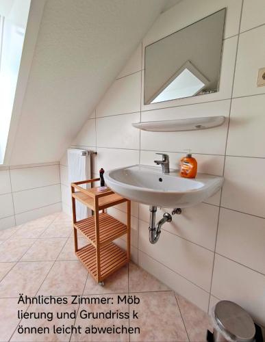 a bathroom with a sink and a mirror at Haus Marinus in Puttgarden