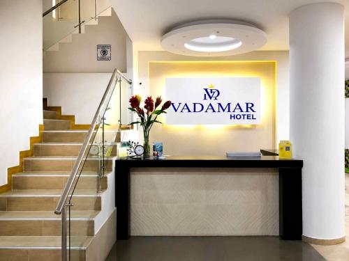 a lobby of a hotel with stairs and a sign at Vadamar Hotel Collection Rodadero in Gaira