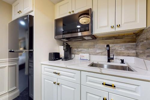 a kitchen with a sink and a microwave at Nurse-Ready Studio Retreat! 2 Mi to Dtwn Holyoke in Holyoke