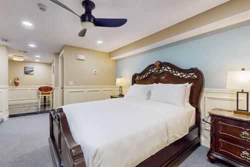 a bedroom with a large bed and a ceiling fan at Nurse-Ready Studio Retreat! 2 Mi to Dtwn Holyoke in Holyoke
