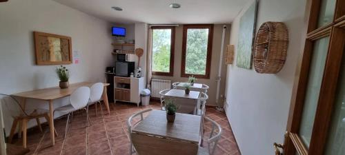 a living room with a table and a dining room at Masllandrich Hostal Rural in Porqueres
