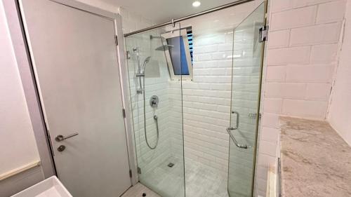 a bathroom with a shower with a glass shower stall at Century Stay by Bait Zain in As Sīfah