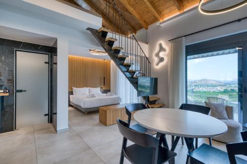 a room with a bed and a table and chairs at Doceo Refined Living in Nafplio