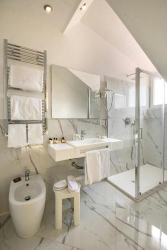 a bathroom with a toilet and a sink and a shower at Sina Maria Luigia in Parma