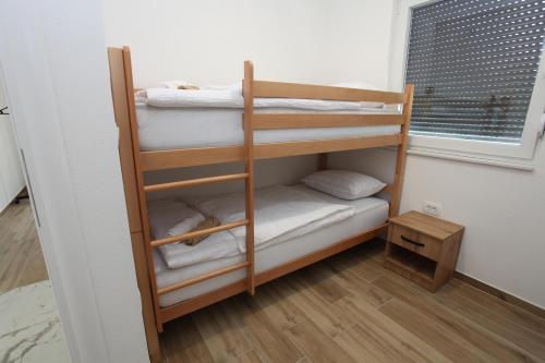 a bunk bed room with two bunk beds and a window at Holiday Home Paradise in Prozor