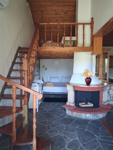 a living room with a staircase and a fireplace at The chill spot in Tagarades
