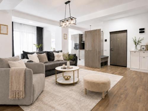 a living room with a couch and a table at Pop Up Aparthotel in Bucharest
