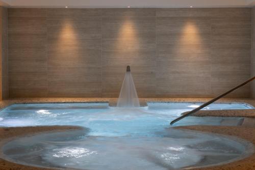 a pool of water with a fountain in a room at Old Course Hotel St Andrews in St. Andrews