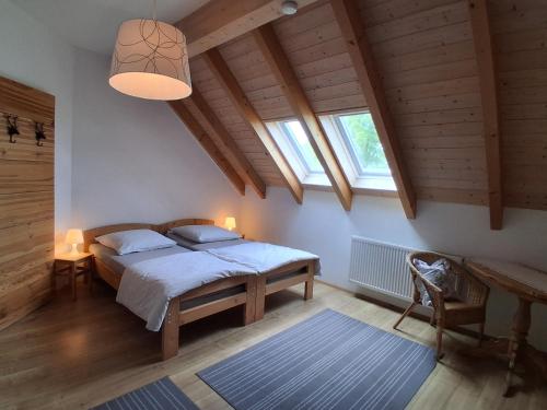a bedroom with a bed in a room with wooden ceilings at Ferienwohnung Elisabeth in Riedenburg